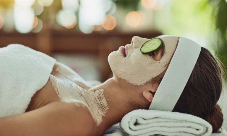 a woman receiving a face mask and cucumber treatment at a rehoboth beach spa