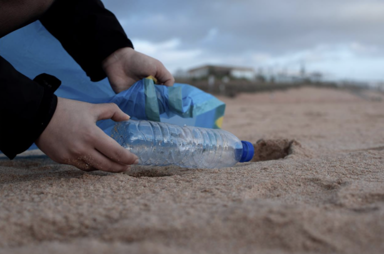 picking up trash on the beach