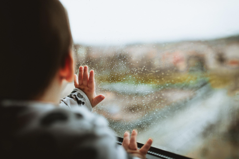 Family reunion - child looking through glass window