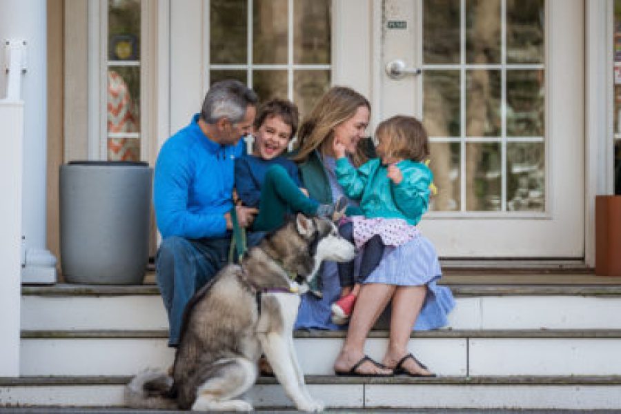 family on the porch with a dog